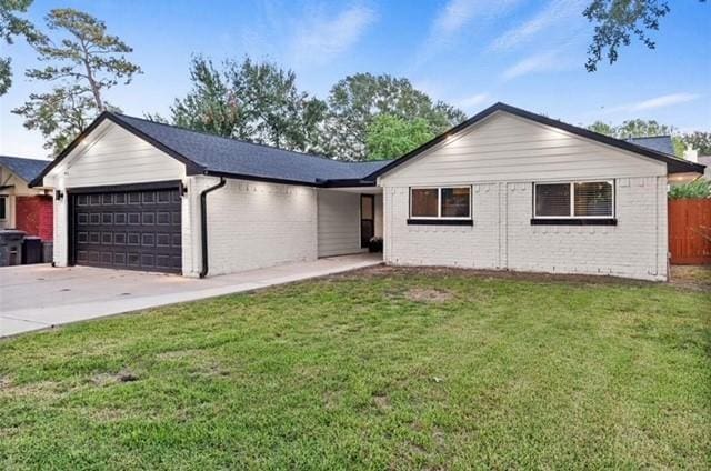 ranch-style house featuring a garage and a front lawn