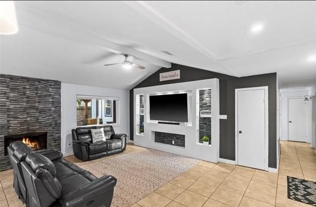 tiled living room with lofted ceiling with beams, ceiling fan, and a fireplace