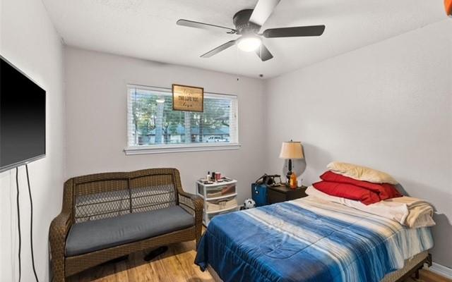 bedroom with ceiling fan and wood-type flooring