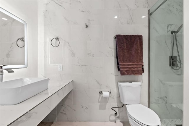 bathroom featuring vanity, a tile shower, and toilet