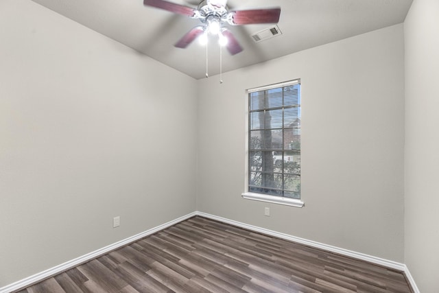 empty room with ceiling fan and dark hardwood / wood-style flooring