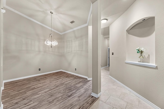 unfurnished dining area featuring lofted ceiling, ornamental molding, and light hardwood / wood-style floors