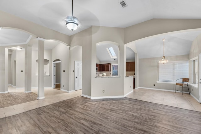 unfurnished living room with high vaulted ceiling, light hardwood / wood-style floors, and ceiling fan