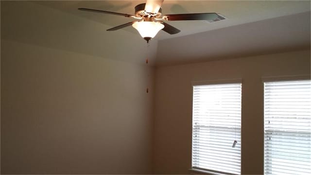 interior space with ceiling fan