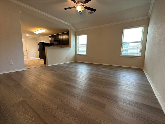 unfurnished living room with dark wood-type flooring, ornamental molding, and ceiling fan