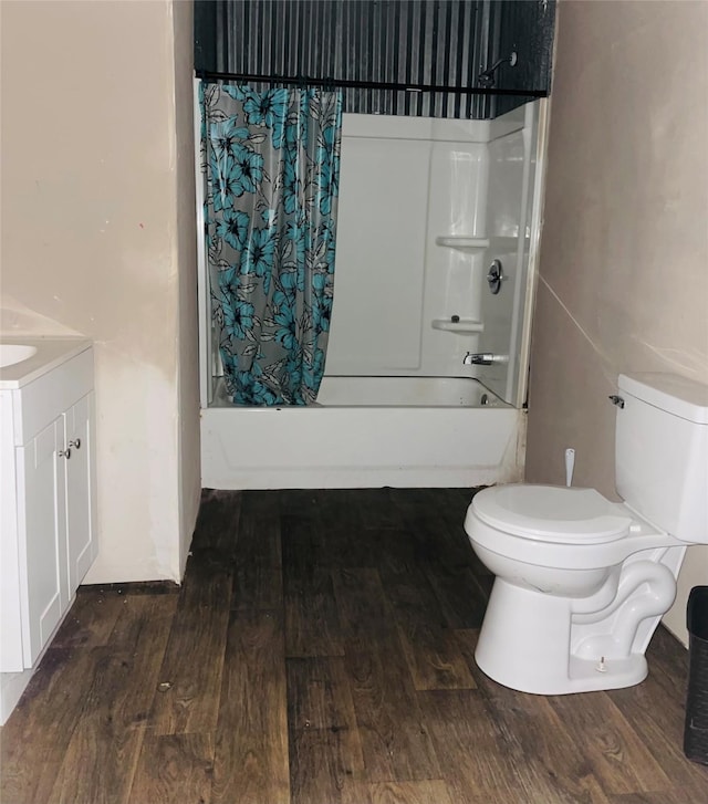 full bathroom with hardwood / wood-style flooring, shower / bathtub combination with curtain, vanity, and toilet