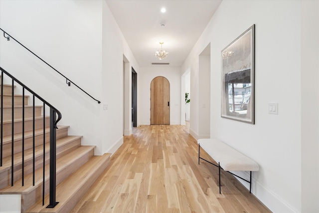 interior space with an inviting chandelier and hardwood / wood-style floors