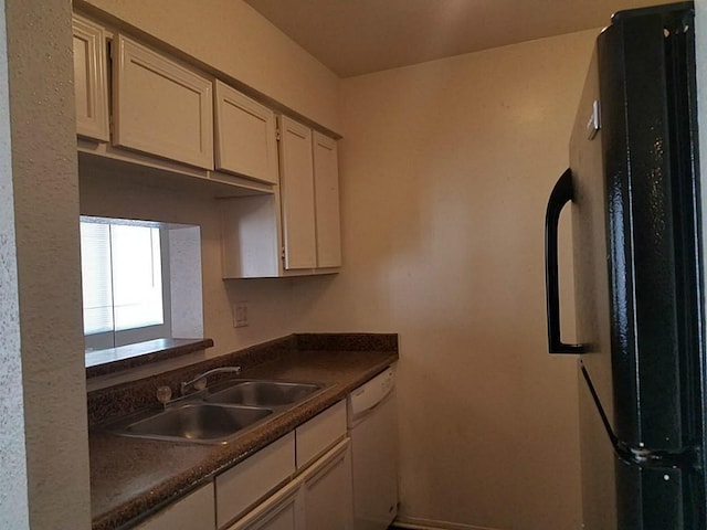 kitchen featuring black refrigerator, sink, and dishwasher