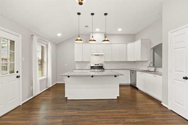 kitchen featuring sink, white cabinetry, a center island, stainless steel appliances, and light stone countertops