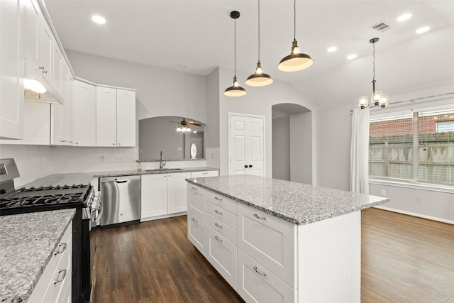 kitchen with white cabinetry, appliances with stainless steel finishes, a center island, and sink