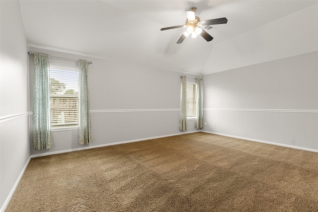 unfurnished room with ceiling fan, lofted ceiling, and carpet