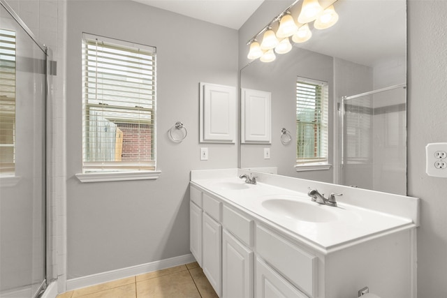 bathroom featuring tile patterned flooring, vanity, and a shower with door