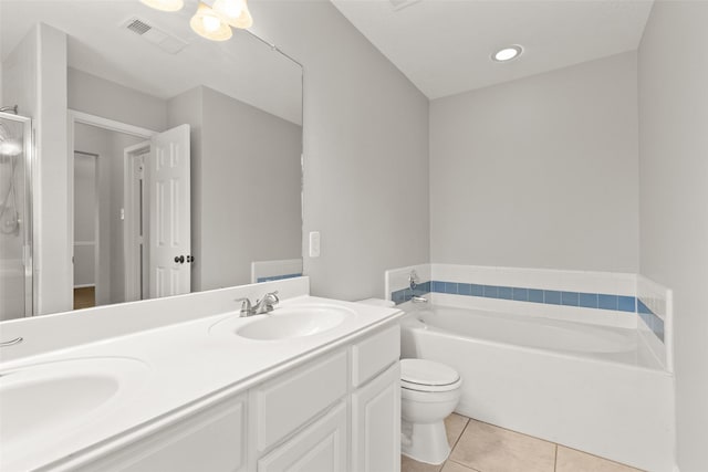 bathroom with toilet, vanity, a bath, and tile patterned flooring