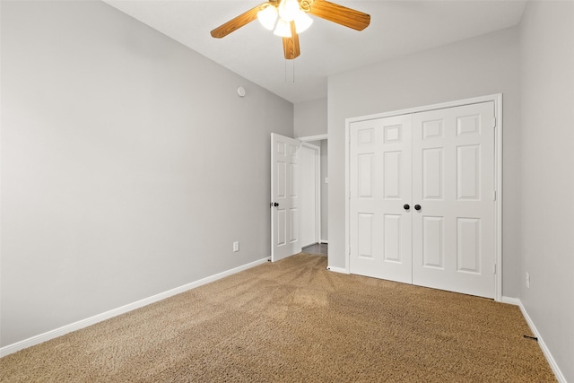 unfurnished bedroom with ceiling fan, carpet floors, and a closet