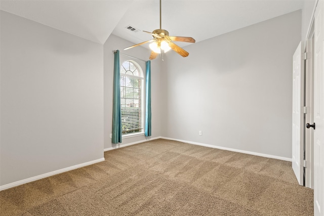 carpeted empty room featuring ceiling fan and vaulted ceiling