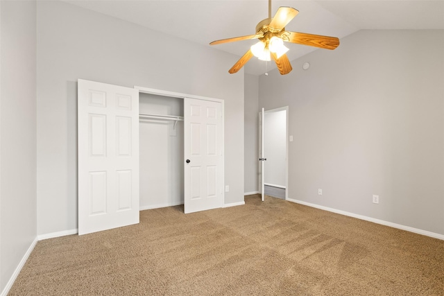 unfurnished bedroom featuring vaulted ceiling, a closet, ceiling fan, and carpet flooring