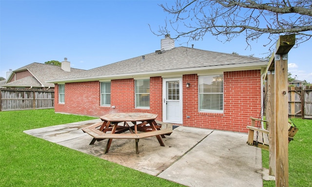 rear view of house featuring a yard and a patio area