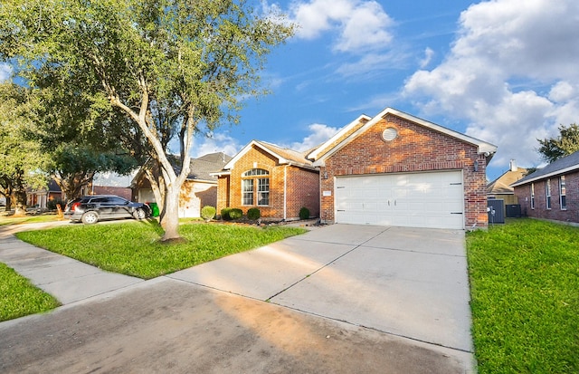 single story home with a garage, a front yard, and cooling unit