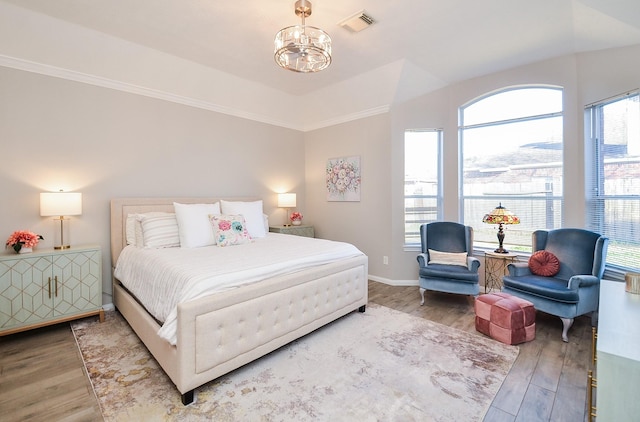 bedroom featuring a chandelier and hardwood / wood-style floors