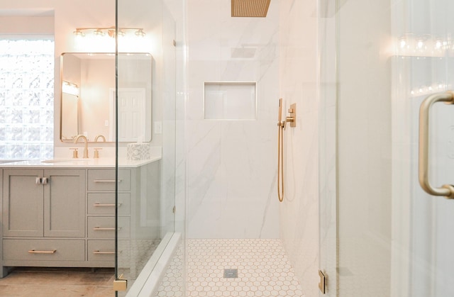 bathroom with vanity and a shower with shower door