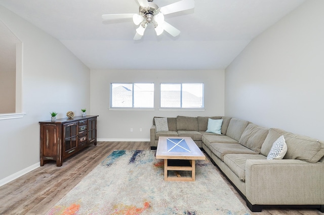 living room with ceiling fan, lofted ceiling, and hardwood / wood-style floors