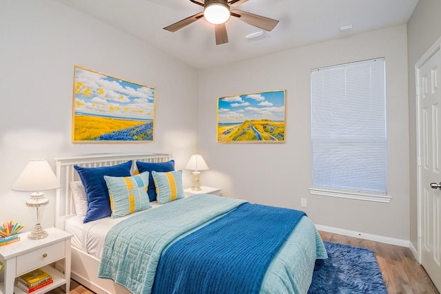 bedroom with ceiling fan and light hardwood / wood-style floors