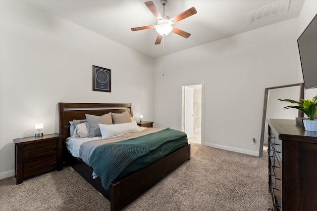 carpeted bedroom featuring ceiling fan and ensuite bathroom