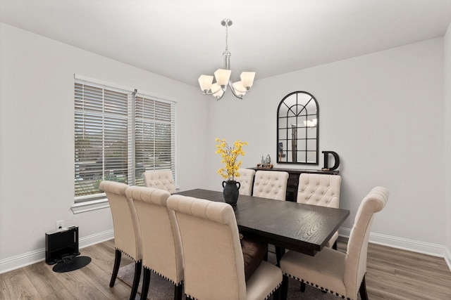 dining room featuring an inviting chandelier and wood-type flooring