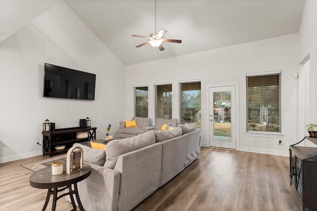 living room featuring wood-type flooring, high vaulted ceiling, and ceiling fan