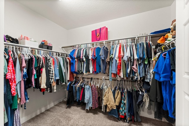 walk in closet featuring carpet flooring