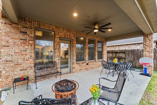 view of patio with ceiling fan and a fire pit