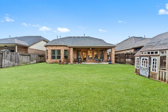 rear view of property with a patio area and a lawn