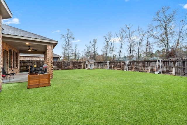 view of yard featuring ceiling fan and a patio area