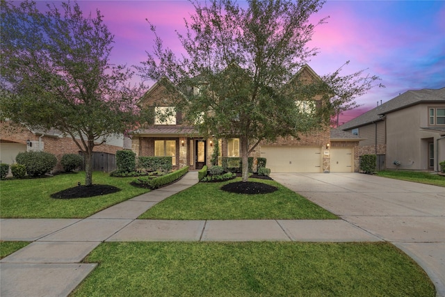 view of front facade with brick siding, concrete driveway, a lawn, fence, and a garage