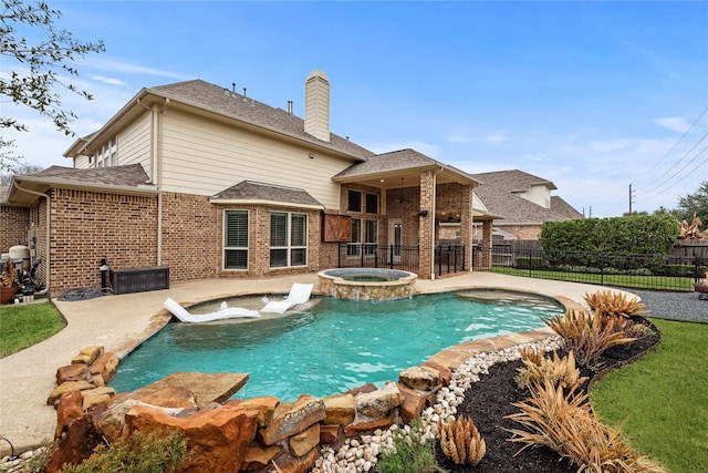 view of pool with a patio area, a pool with connected hot tub, and fence