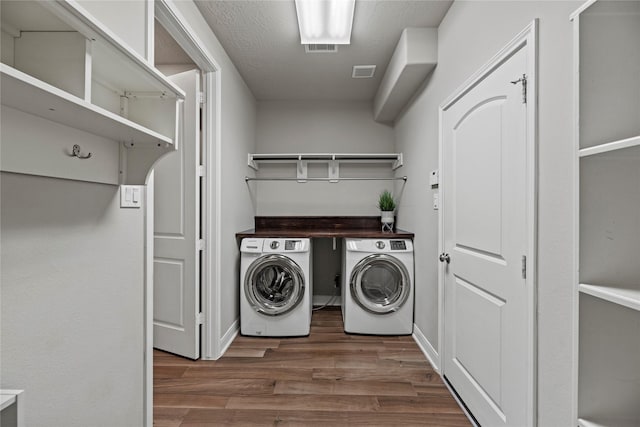 laundry area featuring washer and dryer, laundry area, visible vents, and dark wood-style flooring