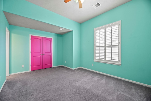 interior space featuring baseboards, visible vents, and a ceiling fan