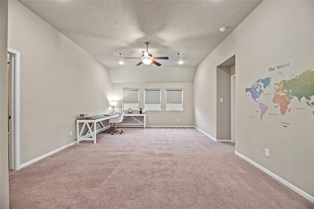 unfurnished office featuring visible vents, baseboards, a ceiling fan, a textured ceiling, and carpet floors