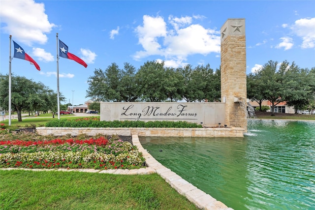 community sign with a water view