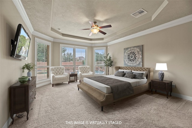 bedroom with a textured ceiling, a raised ceiling, visible vents, and light colored carpet