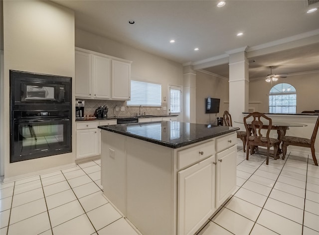 kitchen with black appliances, light tile patterned flooring, white cabinetry, and a center island