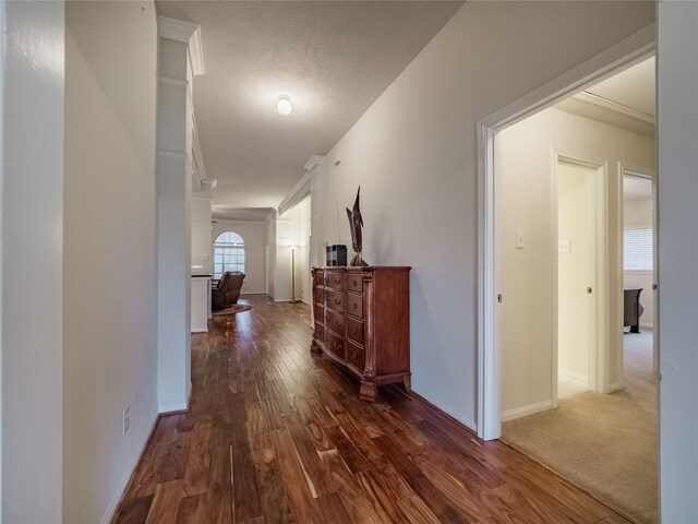 hallway featuring dark hardwood / wood-style flooring and a textured ceiling