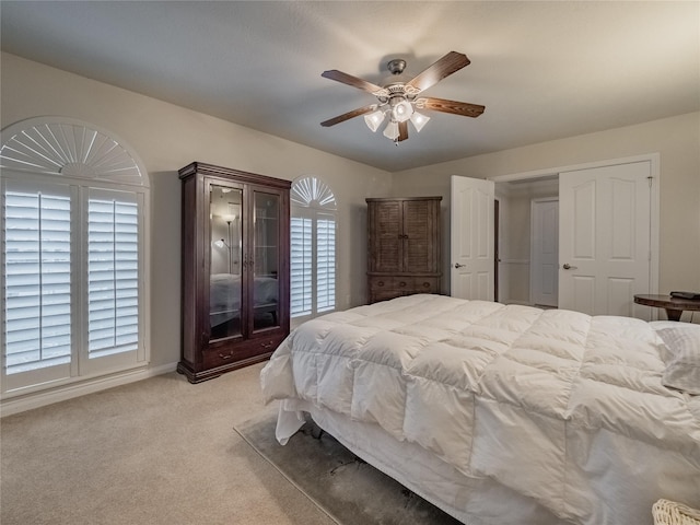 bedroom featuring a ceiling fan and light colored carpet