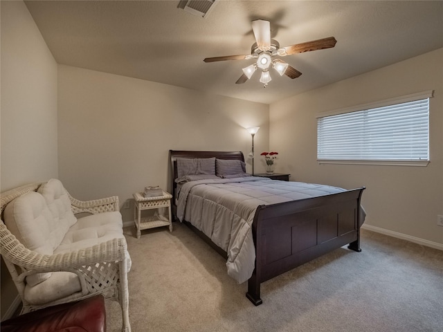 bedroom with baseboards, ceiling fan, visible vents, and light colored carpet