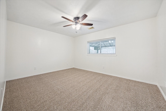 carpeted empty room featuring ceiling fan