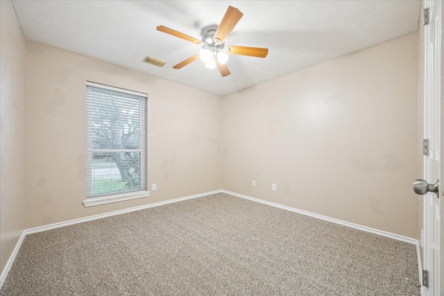 unfurnished room featuring a textured ceiling, carpet floors, and ceiling fan