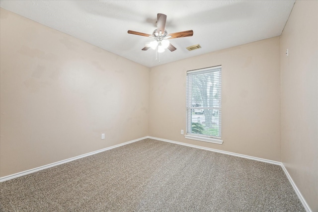 unfurnished room featuring ceiling fan and carpet flooring