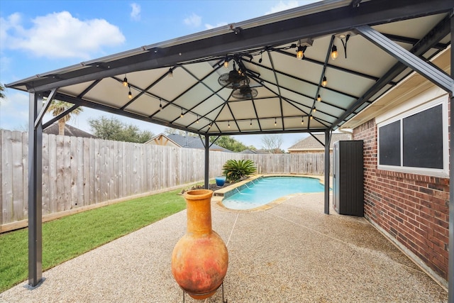 view of swimming pool featuring a patio and a gazebo