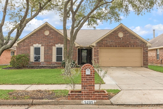 view of front of property with a garage and a front yard