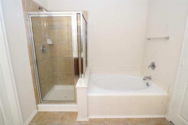 bathroom with tile patterned floors and independent shower and bath